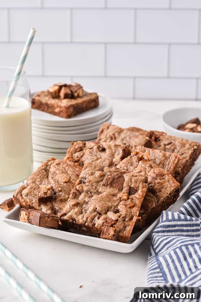 Delicious Chocolate Bar Cookie Bars stacked on a white plate