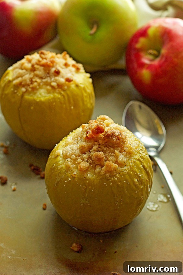 Freshly baked apples with a golden crumble topping, showcasing the delicious texture and inviting aroma.