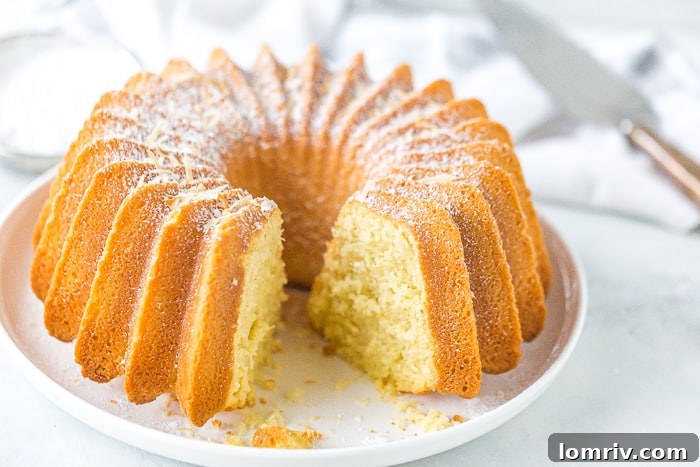 A cracked and broken bundt cake on a cooling rack, illustrating the unfortunate outcome of premature removal from the pan. It symbolizes a moment of baking frustration.