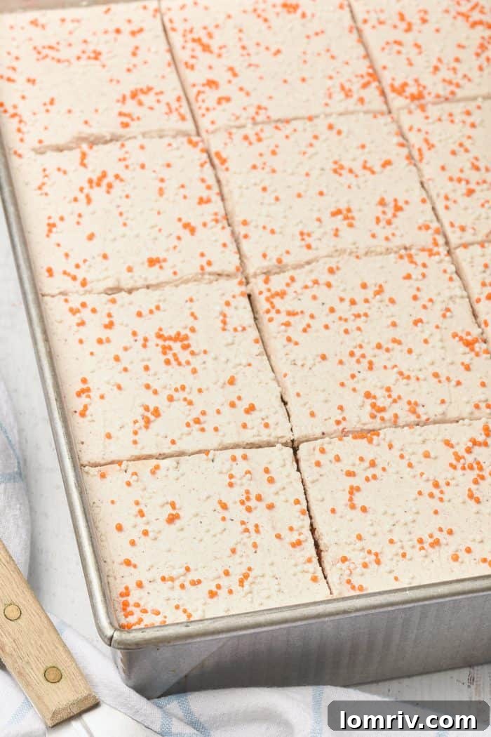 A picture of multiple pumpkin cake bars neatly sliced and arranged.