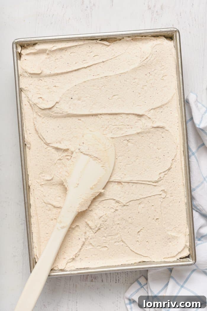 Cooled pumpkin cake generously topped with brown butter frosting.