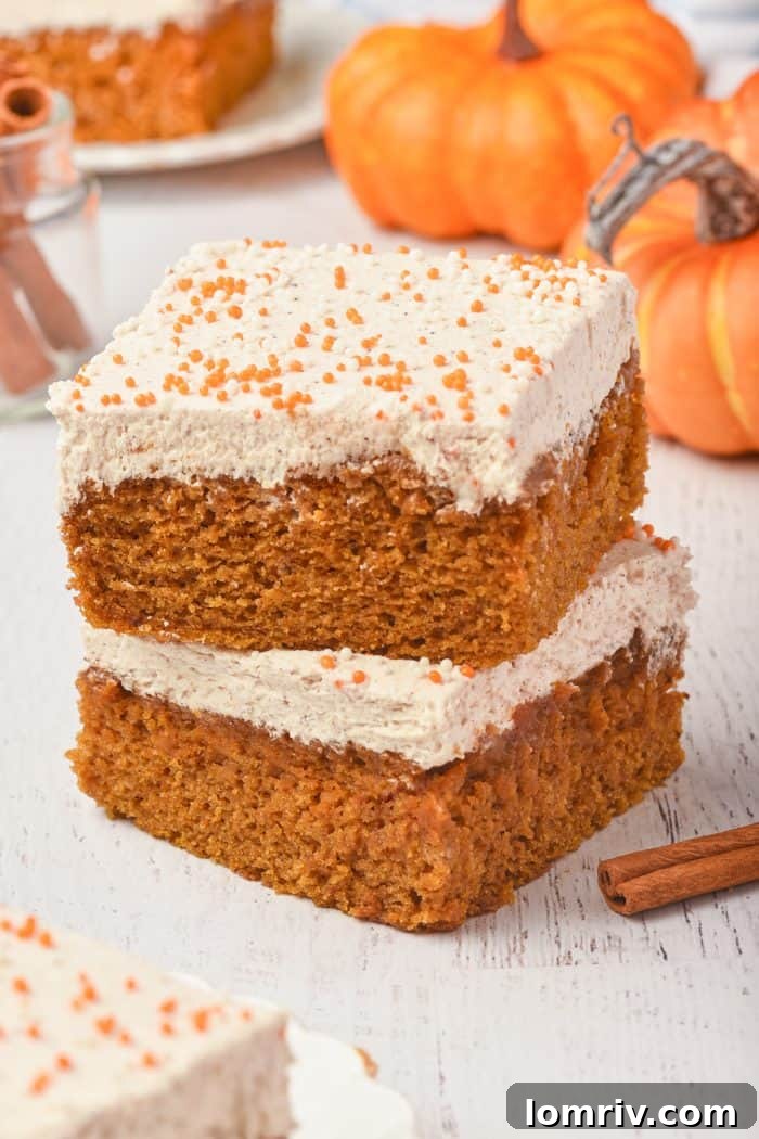 A picture of two pumpkin cake bars artfully stacked on top of each other.