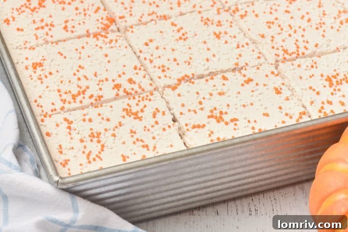 An image of pumpkin cake bars cut into slices, highlighting their perfect texture.