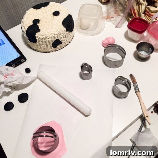 Tools and supplies needed to create an adorable fondant and frosting decorated cow cake, including fondant, cookie cutters, and frosting tips. Get the detailed recipe from BlahnikBaker.com.