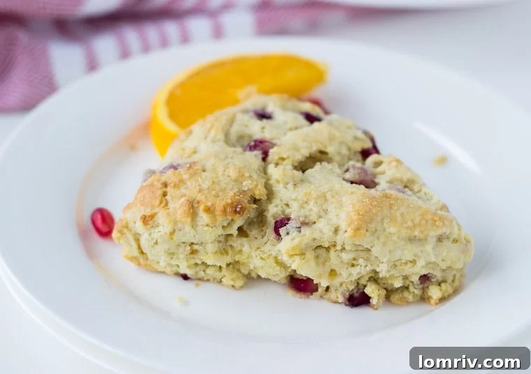 A trio of Pomegranate Orange Scones arranged artfully, showcasing their golden-brown tops and inviting texture.