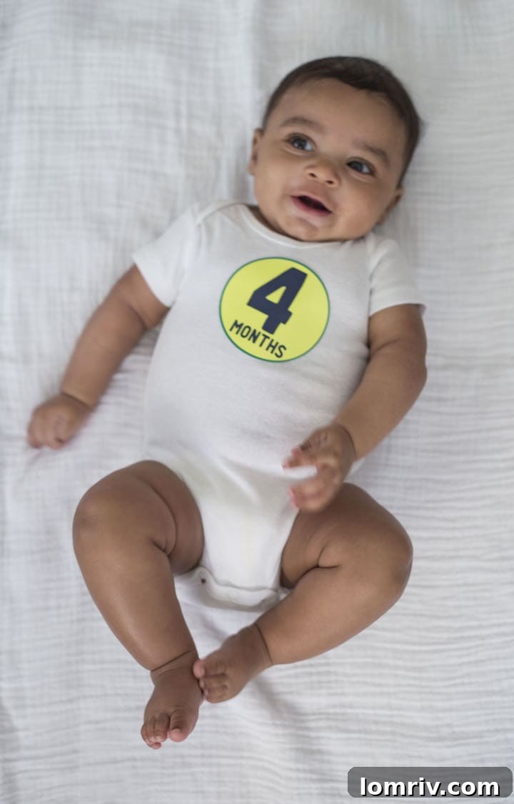 Elliott at four months old, sitting happily.