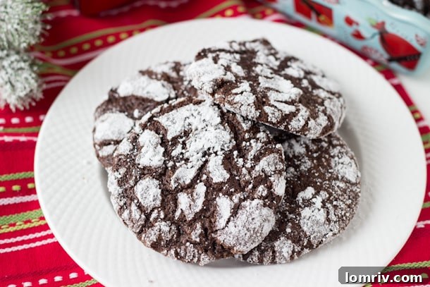 Decadent Double Chocolate Crinkle Cookies dusted with powdered sugar, a classic holiday treat.