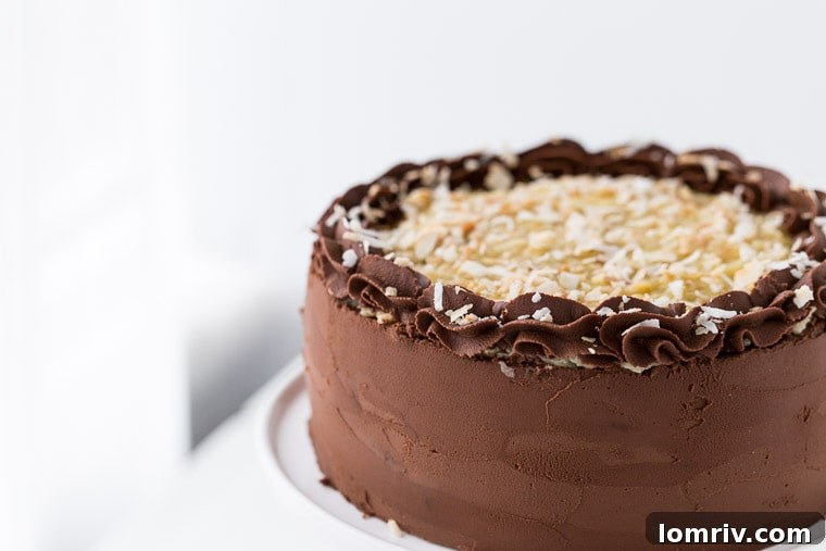 Classic German Chocolate Cake with rich chocolate layers, coconut pecan filling, and chocolate ganache