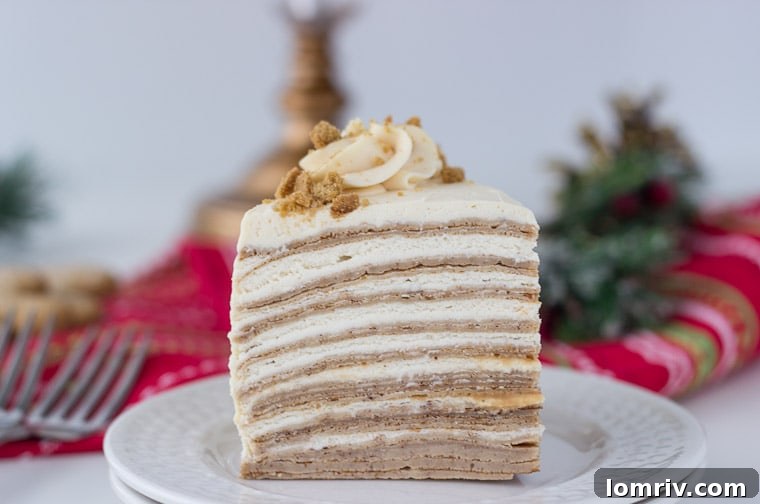 Close-up of a slice of gingerbread crepe cake revealing delicate layers of spiced crepes and creamy caramel filling.
