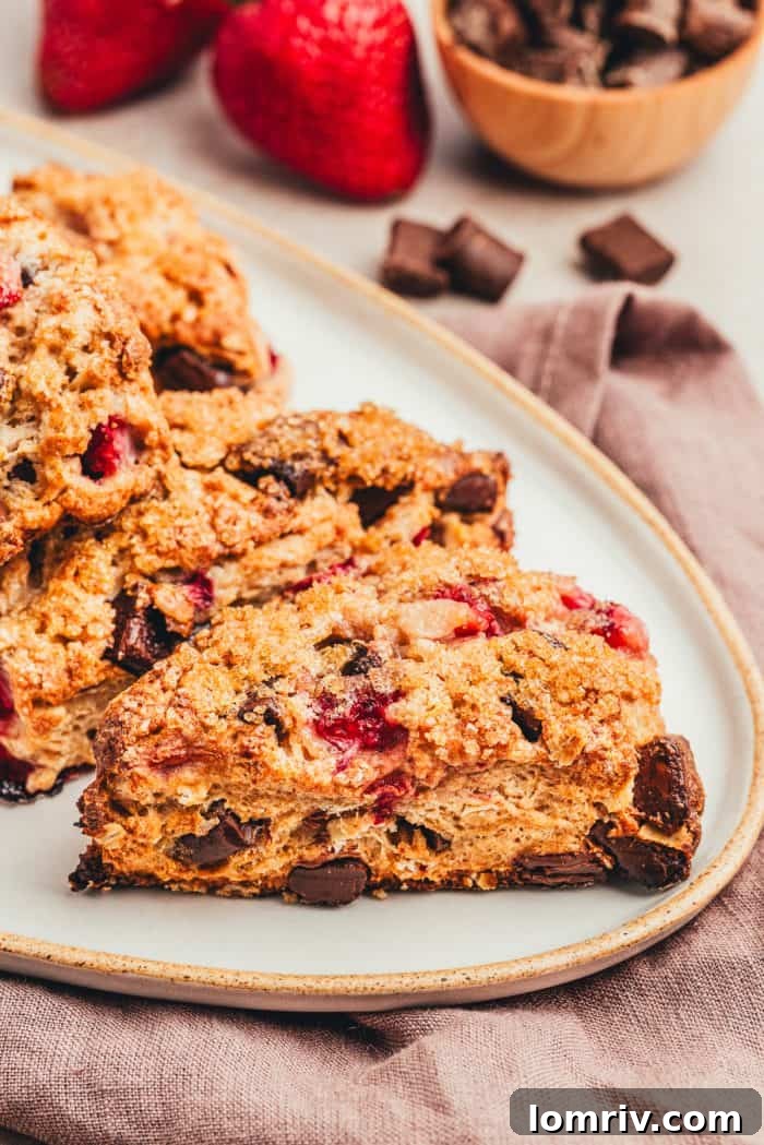 A chocolate strawberry scones on a white platter.