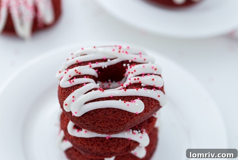 Red Velvet Donuts stacked on a cooling rack, ready to be glazed