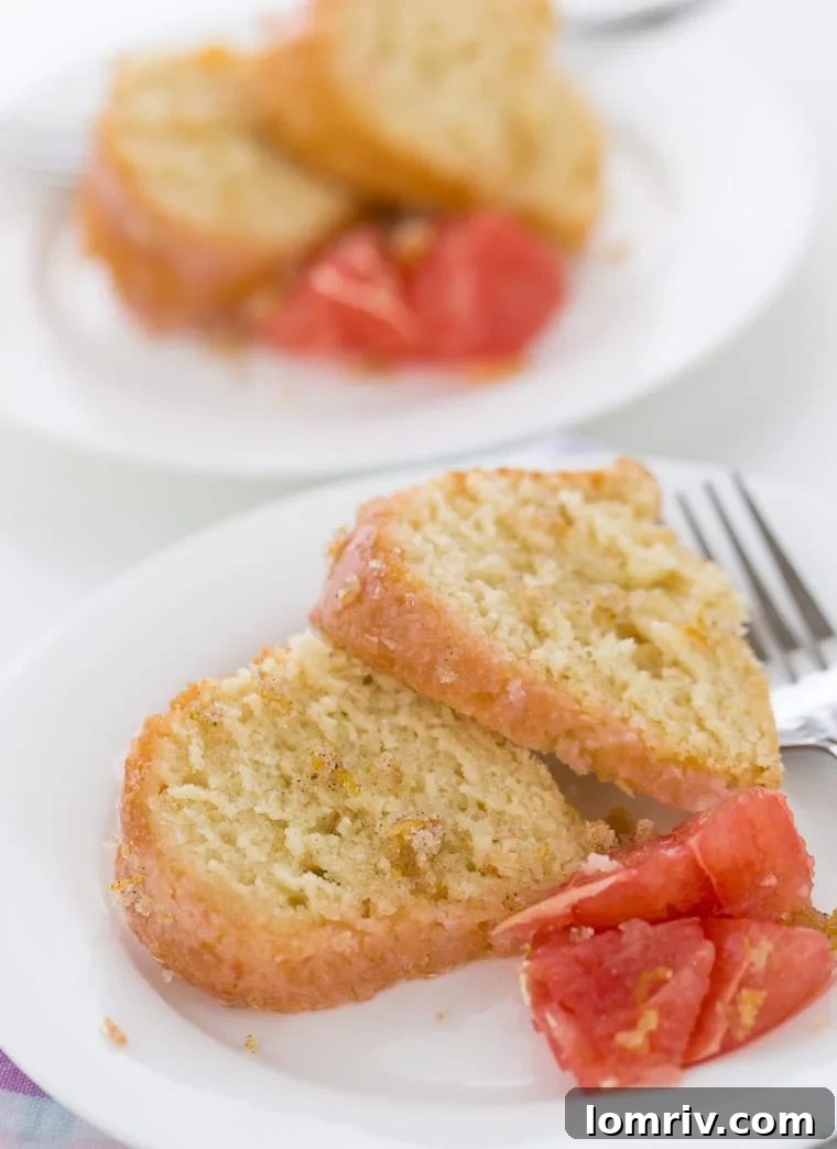 A full grapefruit vanilla bean pound cake, beautifully glazed and ready to be served, highlighting its rich texture and inviting appearance.