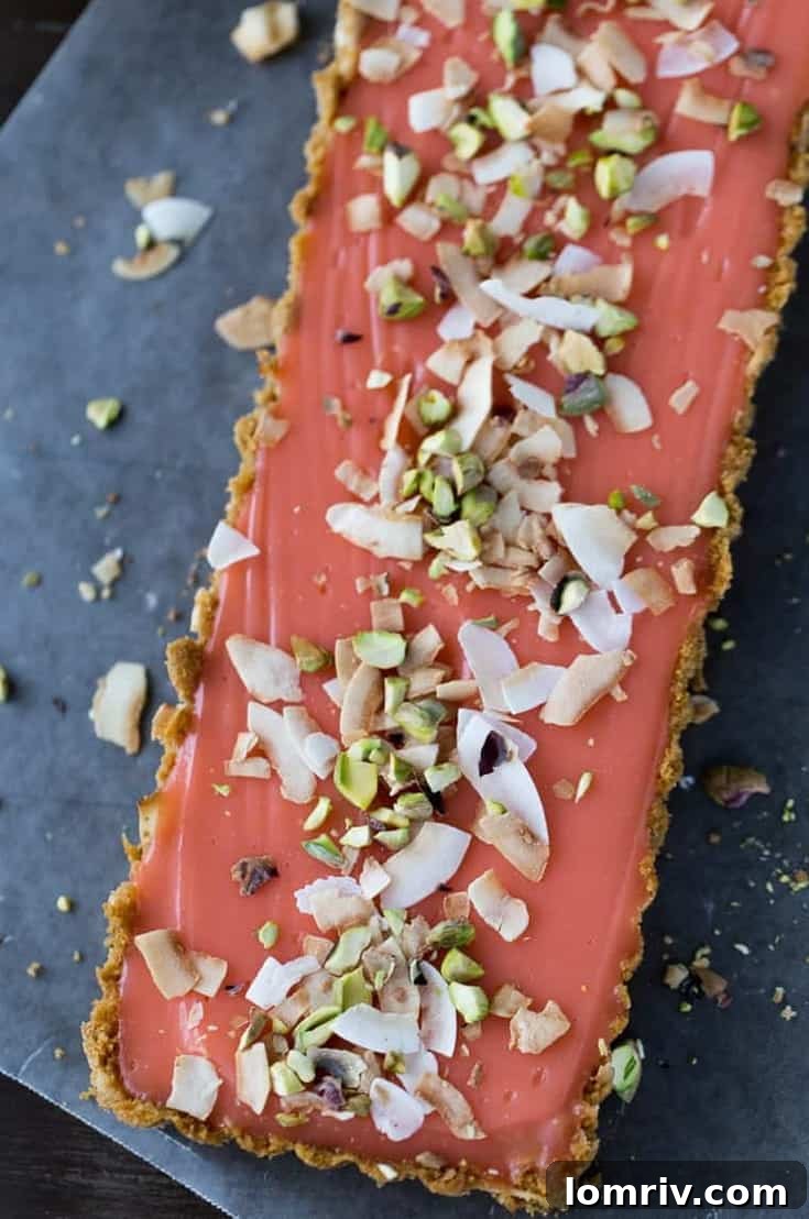 This stunning grapefruit tart features a crunchy graham cracker crust with toasted coconut, perfectly complementing the sweet and tangy homemade grapefruit curd filling. A perfect dessert for citrus lovers.