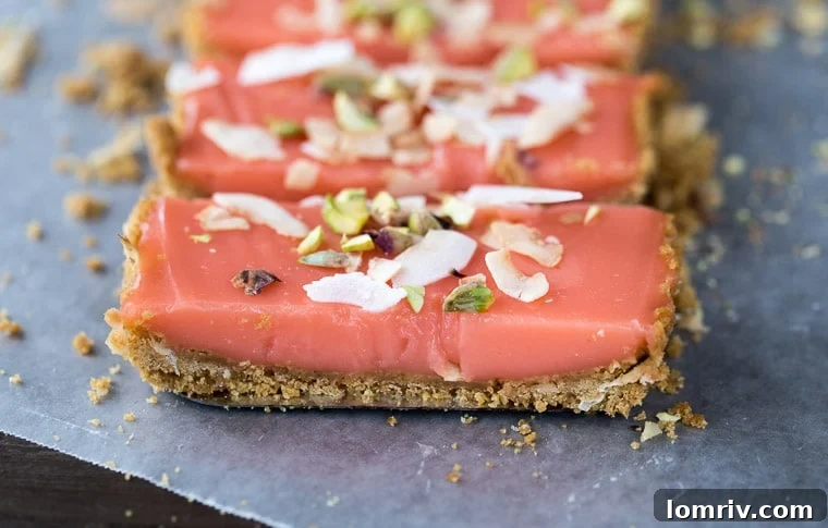 A whole grapefruit tart with a rich, golden crust and a pale pink curd, garnished with toasted coconut flakes and pistachios.