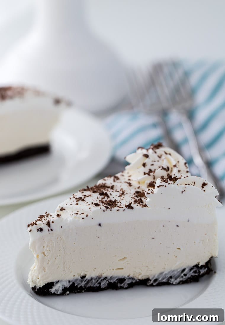This Irish Cream Cheesecake recipe is a no-bake dessert with a cream cheese filling, mint chocolate crust and heavy cream. Perfect for St Patrick's Day. 