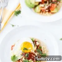 An authentic huevos rancheros recipe with homemade red chile paste, fried eggs and refried beans.