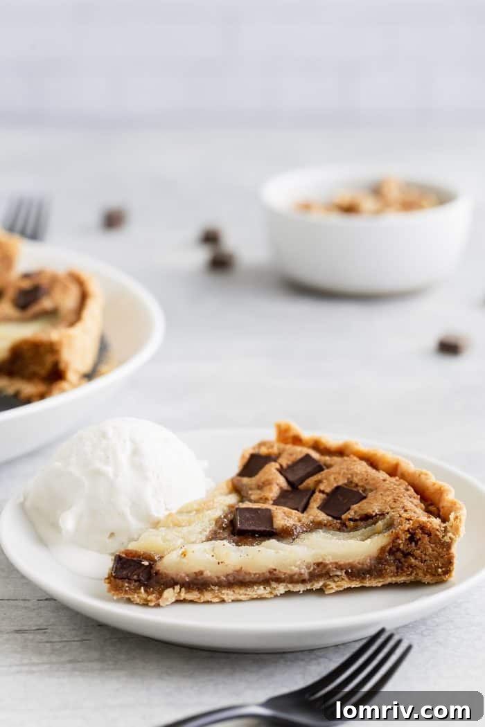 The fully baked Pear Walnut Chocolate Tart resting on a cooling rack, golden brown and glistening, indicating it's perfectly cooked and ready to be enjoyed. The visual appeal makes it an ideal centerpiece for any dessert table.