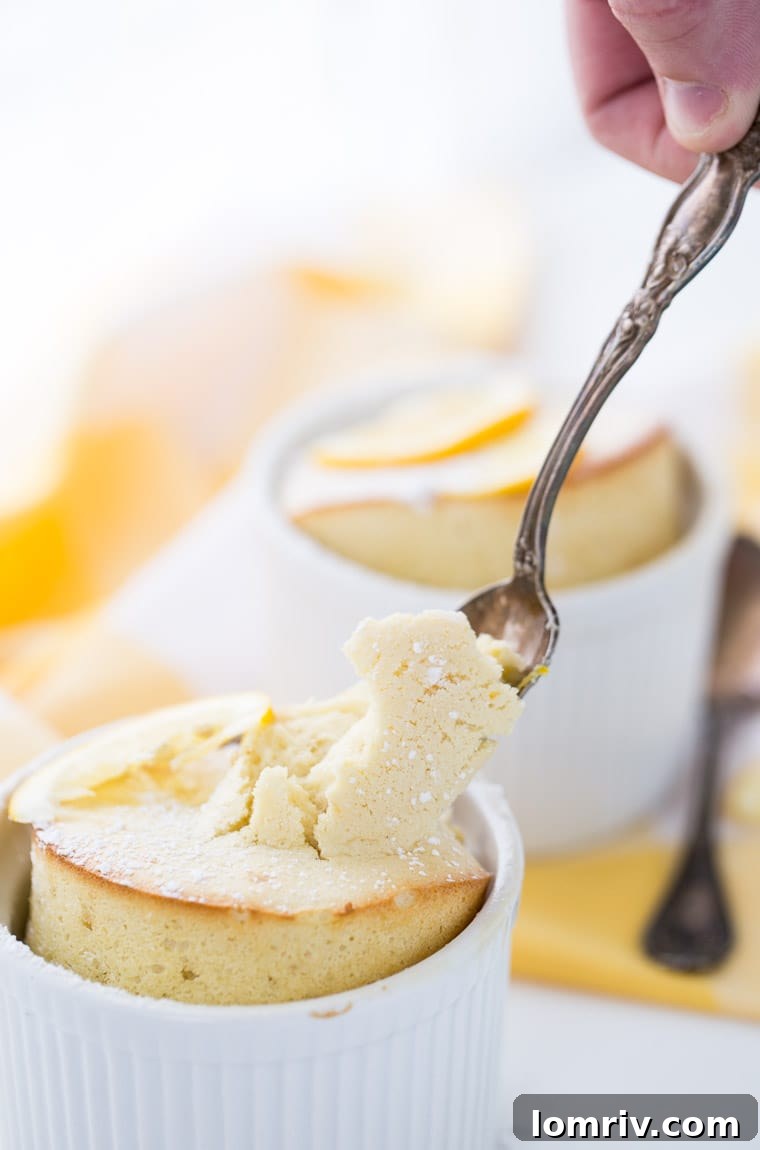 A close-up of a perfectly risen Meyer Lemon Soufflé, rich and bursting with citrus flavor