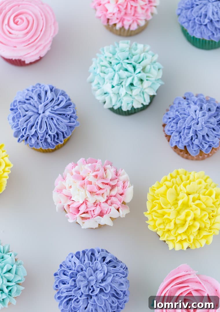 Close-up of elegantly piped flower cupcakes, showcasing various floral designs like roses and hydrangeas, ideal for spring baking projects.