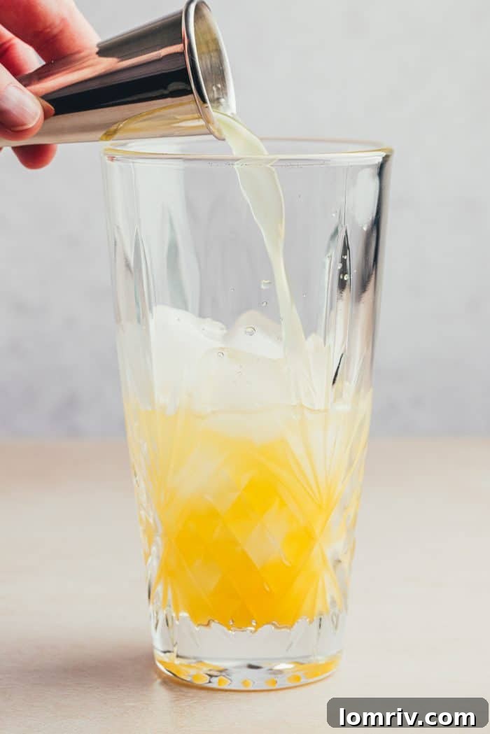 A glass filled with orange juice.