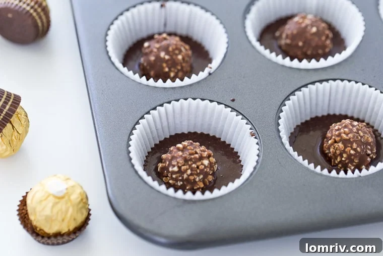 Adding a Ferrero Rocher to the cupcake batter for a delightful surprise.