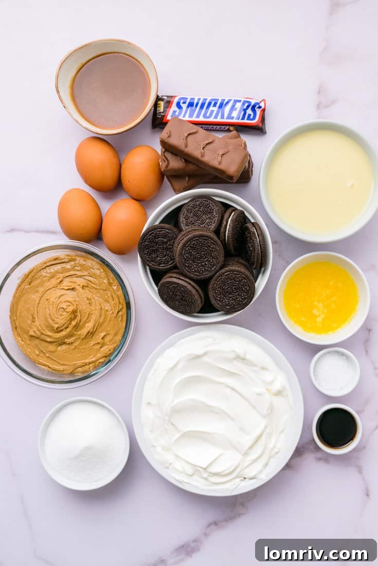 Ingredients for Snickers Peanut Butter Cheesecake laid out