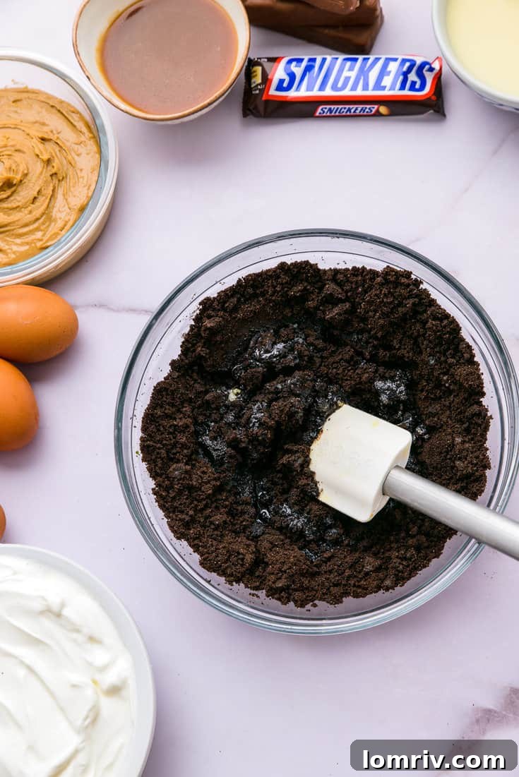 Melted butter being drizzled into Oreo crumbs