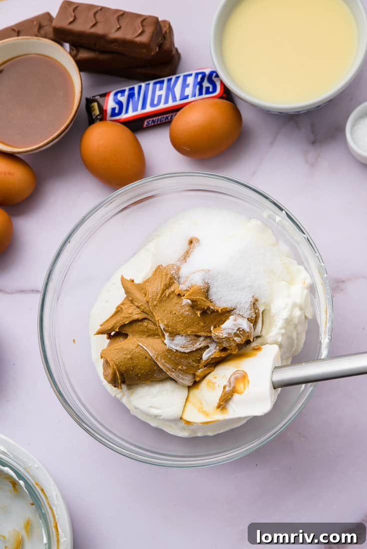 Cream cheese, peanut butter, and sugar being beaten until creamy
