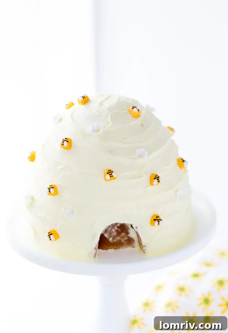 Delicious and beautifully decorated Lemon Honey Beehive Cake with yellow frosting and sugar bees, perfect for a bee-themed party