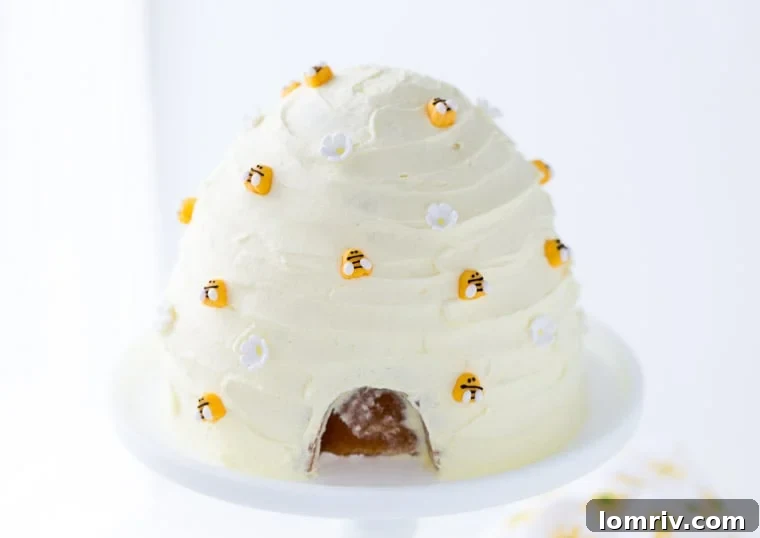 Close-up detail of the Lemon Honey Beehive Cake, showing the delicate icing flowers and playful bumblebee decorations
