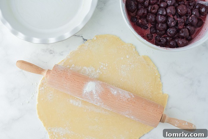 One disc of pie dough rolled out and placed in a pie dish, ready for filling