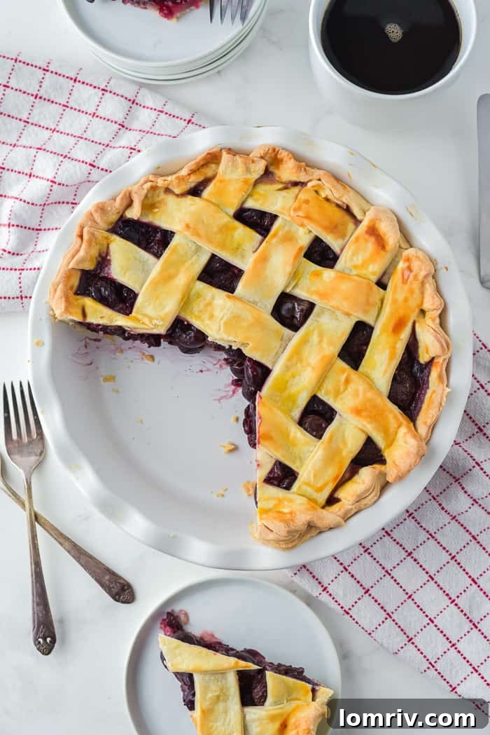 Stunning overhead shot of a baked Cherry Bourbon Pie on a patterned cloth