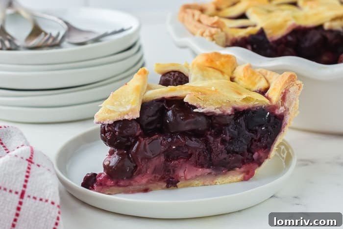 Close-up of homemade cherry pie filling bubbling under a lattice crust