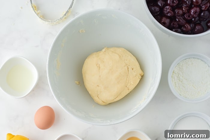 Two discs of pie dough wrapped in plastic wrap, chilling