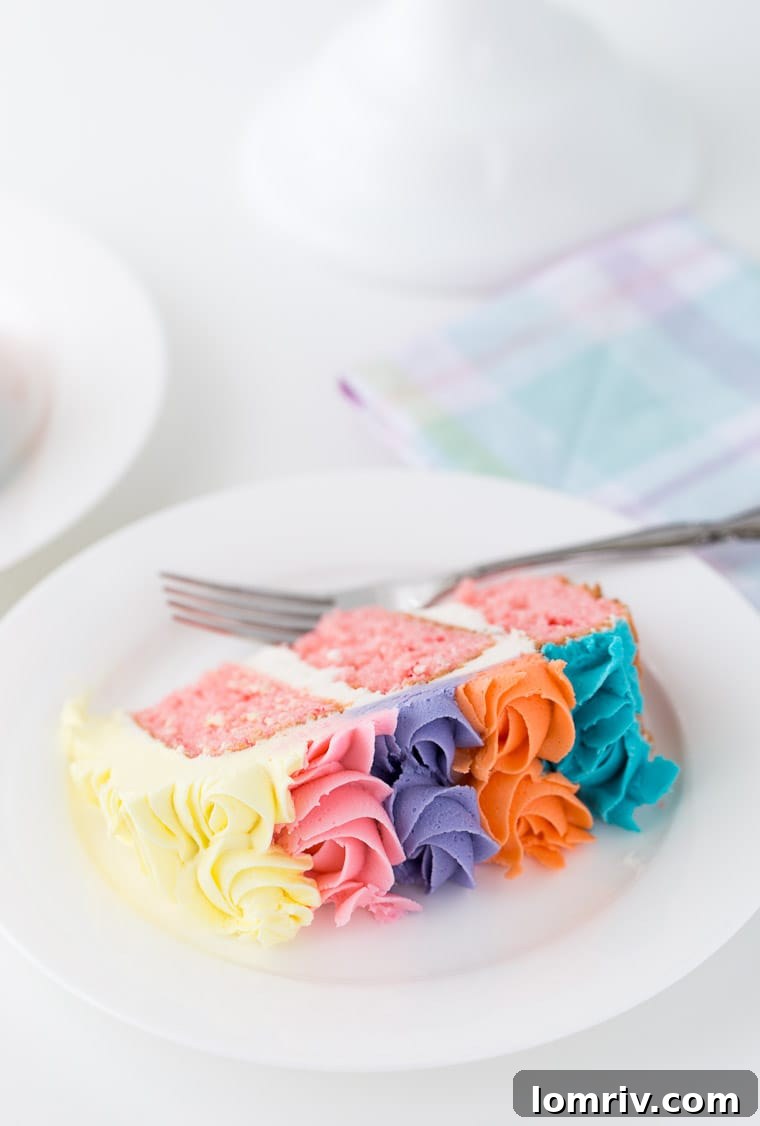 This strawberry rainbow cake is a pretty birthday cake for any girl! With a homemade strawberry cake and whipped vanilla buttercream in colorful swirls