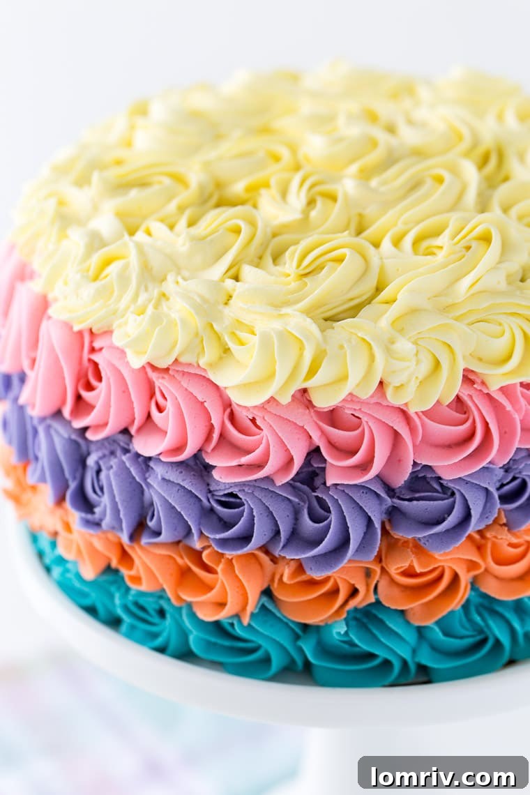 This strawberry rainbow cake is a pretty birthday cake for any girl! With a homemade strawberry cake and whipped vanilla buttercream in colorful swirls.