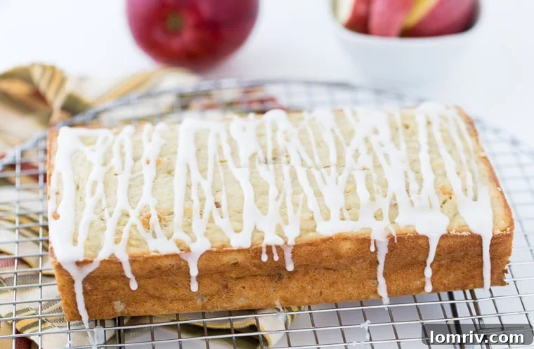 Close-up of a slice of Apple Coconut Bread, showing the moist texture and specks of grated apple.