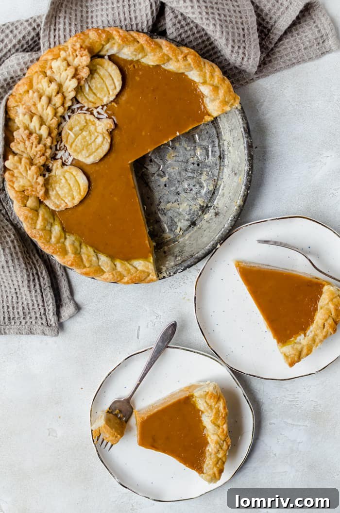 Full Pumpkin Coconut Pie adorned with toasted coconut, a festive holiday treat.