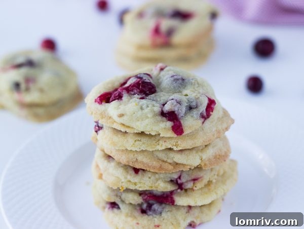 Zesty Cranberry Orange Vanilla Cookies on a wooden board, showcasing festive flavors
