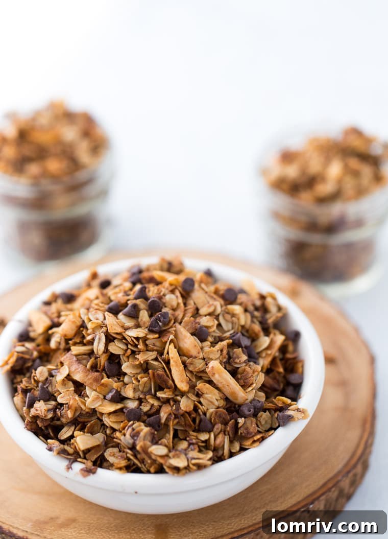 Serving Homemade Coconut Chocolate Chip Granola with Yogurt and Berries