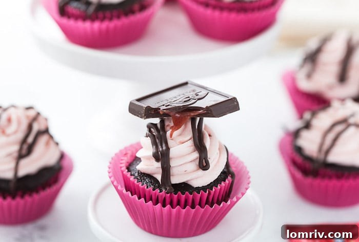 Close-up of a decorated Chocolate Strawberry Cupcake, showcasing the rich frosting and Ghirardelli chocolate square