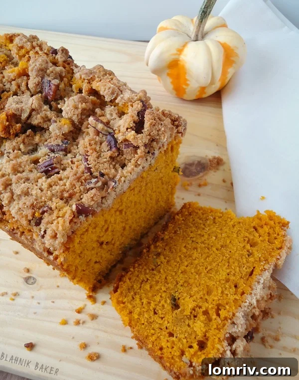 A whole loaf of Brown Butter Pumpkin Sage Bread artfully presented, showcasing the golden-brown streusel.