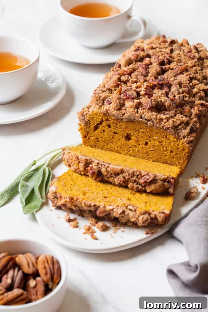 A whole loaf of Brown Butter Pumpkin Sage Bread cooling on a wire rack after baking.