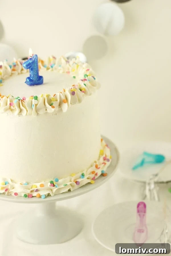 Cherry Vanilla Champagne Cake, the ultimate dessert for New Year's Eve celebrations. Featuring moist vanilla cake, a sweet cherry champagne filling, and creamy champagne buttercream. Recipe on AClassicTwist.com