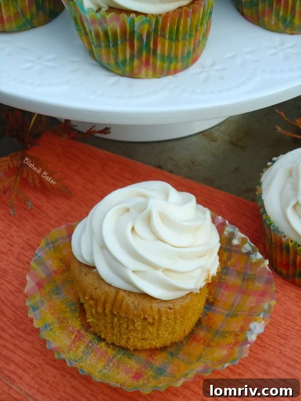 Delicious Pumpkin Spice Cupcakes with a swirl of caramel cream cheese frosting