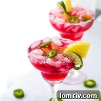 An easy and refreshing Hibiscus Margaritas with sweet pineapple infused syrup and hint of spicy with jalepenos. The perfect mix of sweet and spicy.