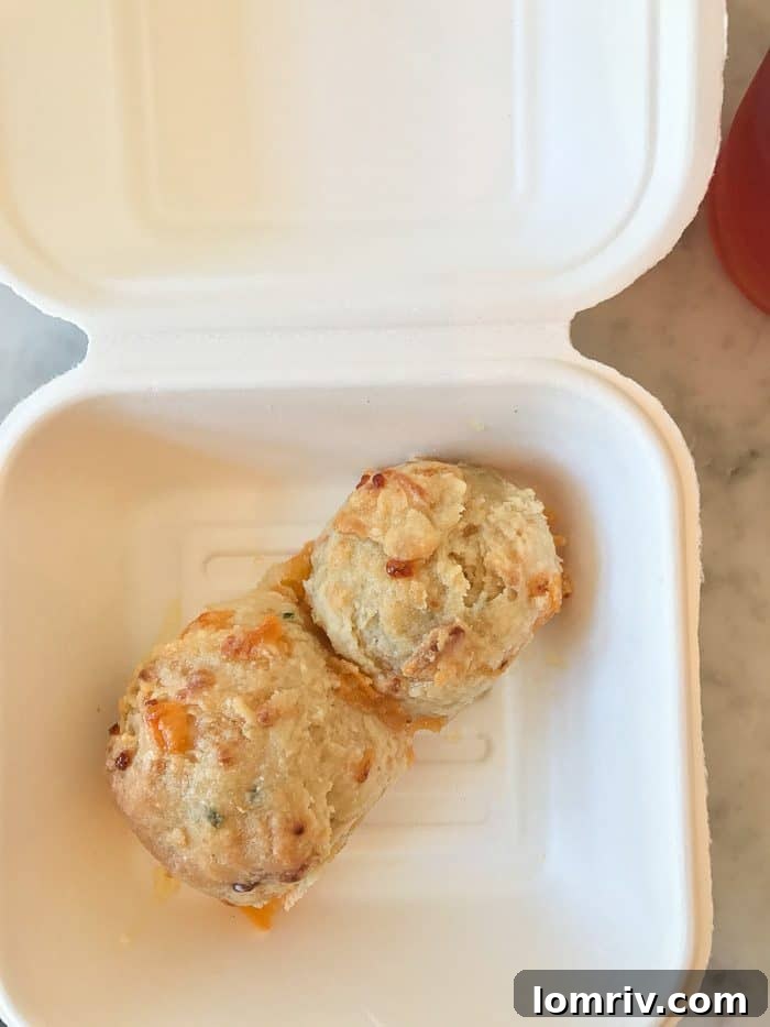A mouth-watering view of Callie's signature cheese and chives biscuit, showcasing its savory appeal.