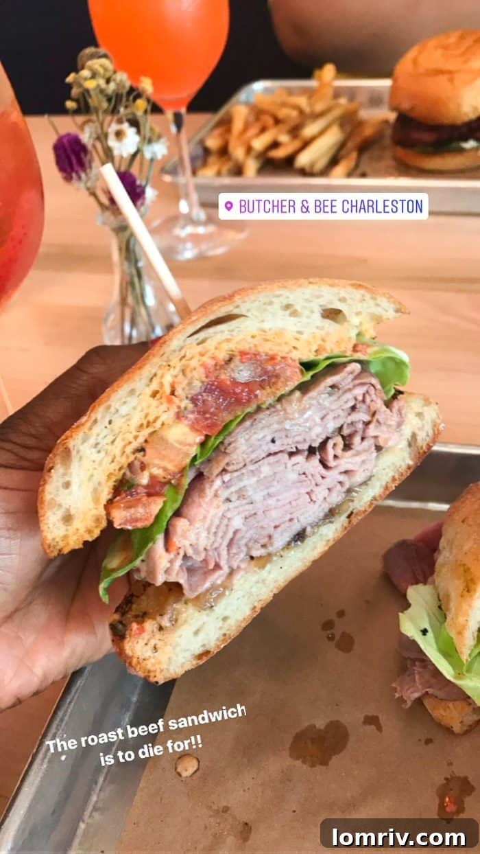 A gourmet roast beef sandwich from Butcher & Bee, bursting with fresh ingredients and flavor, perfect for lunch.