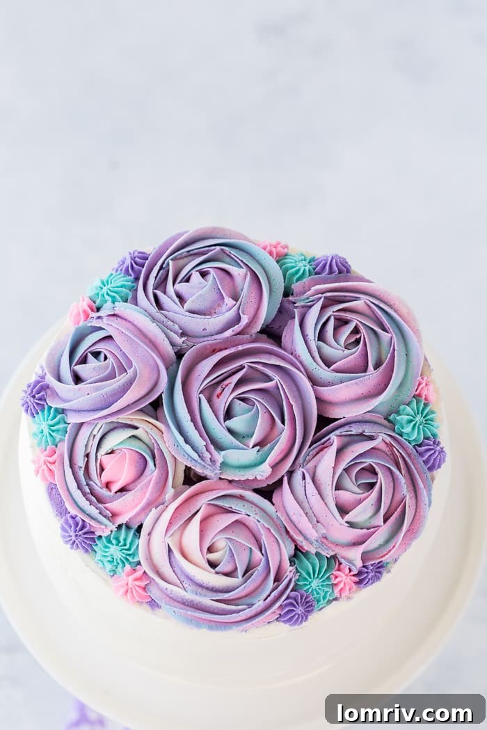 The journey to creating this White Chocolate Rose Cake involved experimenting with rose cake designs, resulting in a beautifully swirled frosting effect.
