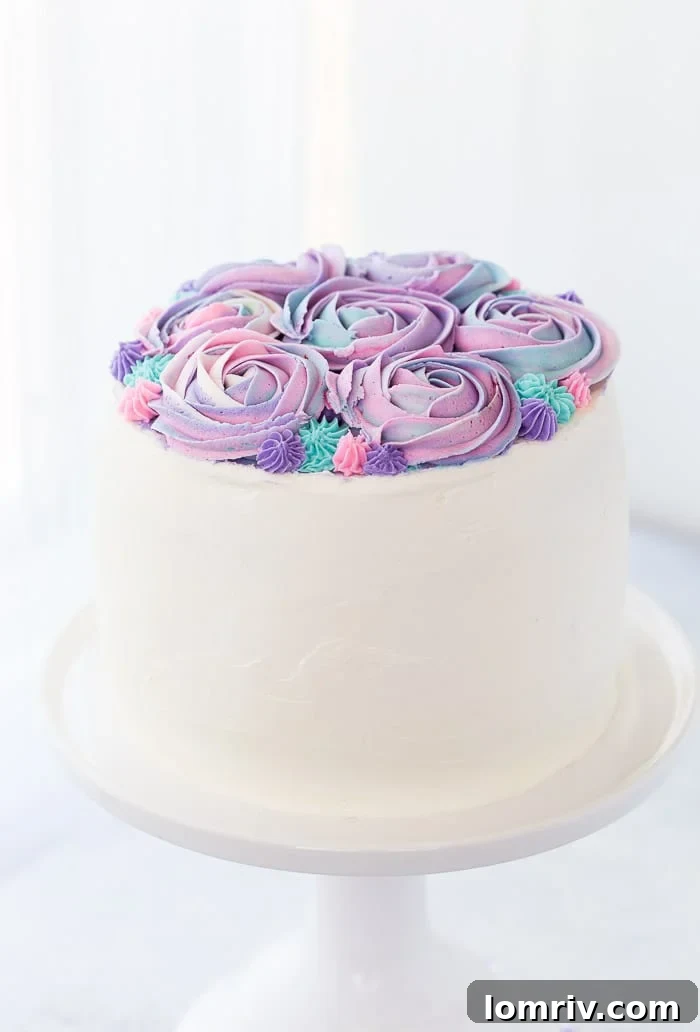Layers of moist vanilla bean cake, infused with rosewater, are generously coated in a dreamy whipped white chocolate frosting for this stunning dessert.